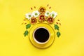 Pattern of flowers of red and white asters, green leaves and a cup of hot coffee Americano on yellow background Royalty Free Stock Photo