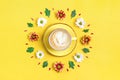 Pattern of flowers of red and white asters, green leaves and a cup of hot coffee cappuccino on yellow background Royalty Free Stock Photo