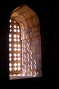 Pattern formed by sunlight passing through stone window grillwork at Jami Masjid in Mandu Royalty Free Stock Photo