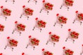 Pattern of fresh strawberry in shopping cart on pink background. Online shopping, Valentines Day minimalistic concept.