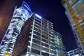 Pattern of Generation Park office buildings windows illuminated at night.