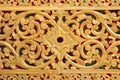 Pattern of gold flower carved on stone wall background Royalty Free Stock Photo