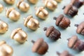 Pattern of golden and natural oak tree acorns on light green background