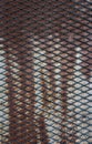 Pattern of grate on grunge rusty metal plate Royalty Free Stock Photo