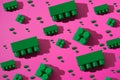 Pattern green plastic blocks of children`s constructor on a pink background Royalty Free Stock Photo