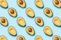Pattern of halves of avocado on a blue background