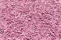 Pattern of healthy organic tofu cat litter of pastel pink color. Natural background.