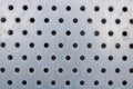 Pattern of holes on a silvery metal window shutter Royalty Free Stock Photo