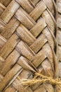 Pattern of interweaving brown palm leaves