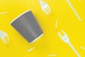 Pattern of broken plastic forks, and plastic cup on a yellow background. Ecology problem. Royalty Free Stock Photo