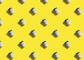 Pattern with lot of disposable paper white and blue cups for coffee or tea on yellow background. flat lay