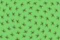 Pattern made of black spiders on a green background.