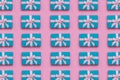 Pattern made of blue colored gift boxes on pink background.