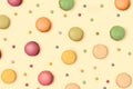 Pattern made of delicious macarons and colorful coated chocolate confectionery. Splendid ivory color background Royalty Free Stock Photo