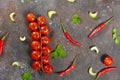 Pattern made of fresh vegetables and branch of cherry tomatoes on dark stone background. Royalty Free Stock Photo