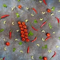 Pattern made of fresh vegetables and branch of cherry tomatoes on dark stone background. Royalty Free Stock Photo