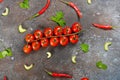 Pattern made of fresh vegetables and branch of cherry tomatoes on dark stone background. Royalty Free Stock Photo