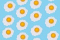 Pattern made of fried eggs on blue background Royalty Free Stock Photo