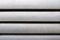 Pattern made of heavy aluminum bars lying on each other on stack. Royalty Free Stock Photo