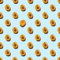 Pattern made with slices of fresh orange apricot isolated on a blue background, copy space