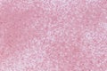 A pattern made of soft pink sand with crimson tiny particles scattered on white background Royalty Free Stock Photo