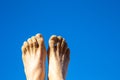 pattern of male sandy foot at the beach under clear blue sky Royalty Free Stock Photo