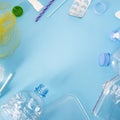 Pattern of many plastic bottles, caps, tubes, bags, tablets packaging arranged as a copy space frame on blue background. Saving th