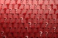 Pattern with many randomly arranged red question marks on red background. Royalty Free Stock Photo