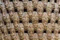 Pattern of many wood carved heads on chair at traditional Fon`s palace in Bafut, Cameroon, Africa