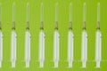 Pattern, medical syringes on a green background