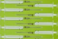 Pattern, medical syringes on a green background