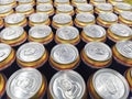 Pattern from much of drinking cans of beer. Metal beer cans background. Drink cans