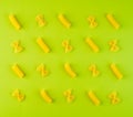 Pattern of pasta on green background, food ingredient, top view