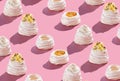 Pattern, Pavlova cakes 4 stages of preparation. on a pink background with hard shadows
