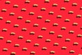 Pattern of peanuts with shell. Fashionable sunny pattern of peanuts with shell on a bright red background. Colorful pattern. View Royalty Free Stock Photo