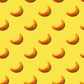 Pattern of pieces of pumpkin on a yellow background. Color of the year 2021 Illuminating. Vegetarian healthy food concept