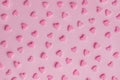 Pattern. Pink confectionery hearts on pink background, texture