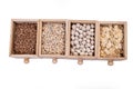 Pattern of raw cereals, beans and seeds, top view texture, mix of groats in square wooden box. Small wooden box with cells with Royalty Free Stock Photo