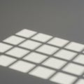 A pattern of rectangular shadows is cast on a gray surface, likely from a window or grid Royalty Free Stock Photo