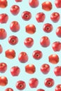 Pattern of red apples in different positions when turning. Light blue background