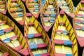 Pattern of red and yellow wooden boats moored next to eah other in Pokhara, Nepal Royalty Free Stock Photo