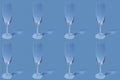 Pattern. Repetition of the image of a champagne glass on a light blue background.