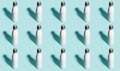 Pattern of reusable eco, steel stainless thermo water bottle white of color, isolated on cyan background.