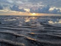 Pattern of sand on low tide beach and water reflection in Pengerang, Johor, Malaysia. Royalty Free Stock Photo