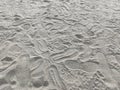 Pattern of sand with trampled footprints from boots on the beach