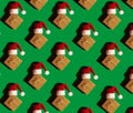 Pattern of Santa hat on paper gift box present on green background. Copy space for your text. Mock up for advertisement