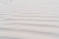 Pattern of sea ripples was left by waves on coastal white sand. Sea coast. Tourism and travel. Calm and serenity.