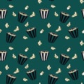 Pattern seamless striped box container with delicious popcorn on green background.