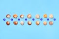 Pattern of seashells and blue glass beads on a light blue background Royalty Free Stock Photo