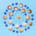 Pattern of seashells, starfish, and blue glass beads on a light blue background. Royalty Free Stock Photo